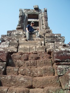 Climbing The Steps Of Angkor Temple